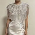 Luxury handmade beaded bridal cape with sequin embroidery and flowing fringe details for wedding dress styling.