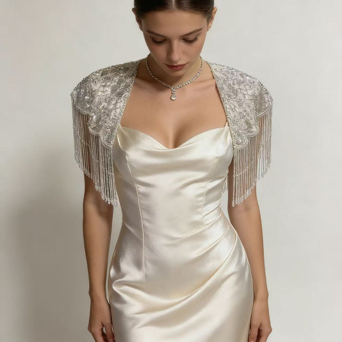 Elegant wedding shoulder wrap featuring intricate beadwork, sparkling sequins, and couture inspired bridal fringe.
