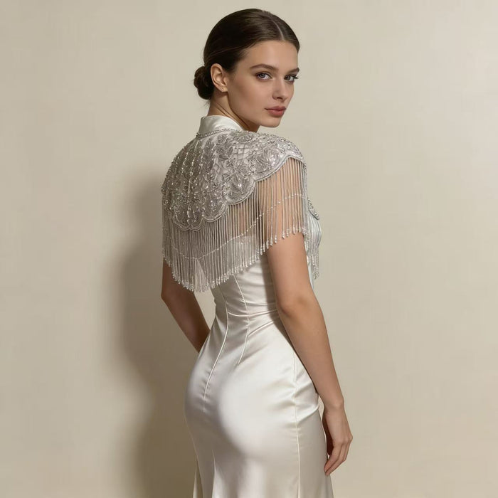 Elegant wedding shoulder wrap featuring intricate beadwork, sparkling sequins, and couture inspired bridal fringe.