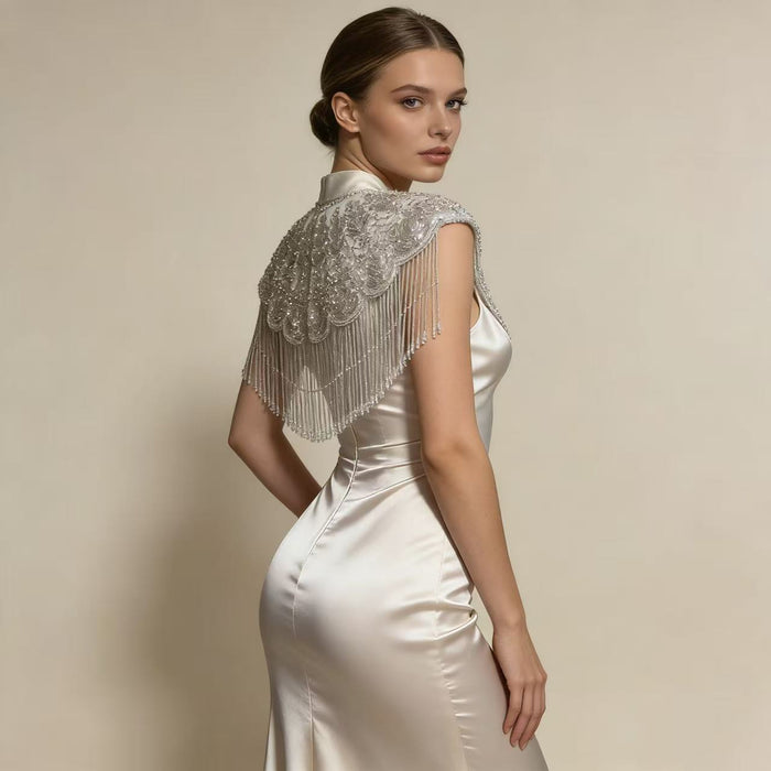 Elegant wedding shoulder wrap featuring intricate beadwork, sparkling sequins, and couture inspired bridal fringe.
