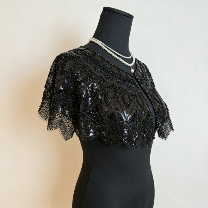 Luxury black gothic wedding shoulder cape with handcrafted bead embroidery and shimmering sequins for formal bridal styling.