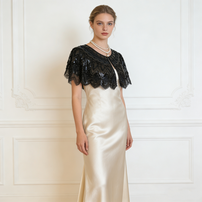 Handmade black bridal capelet featuring intricate sequin bead embroidery, embroidered lace, and elegant scalloped edges.