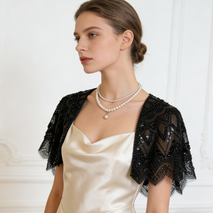 Handmade black bridal capelet featuring intricate sequin bead embroidery, embroidered lace, and elegant scalloped edges.
