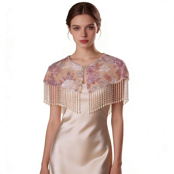 Elegant blush pink bridal shoulder cape with floral embroidery, delicate beadwork, and flowing pearl fringe.