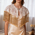 Handmade bridal shoulder cape featuring champagne gold fringe, blush embroidery, shimmering sequins, and delicate seed bead embellishments.
