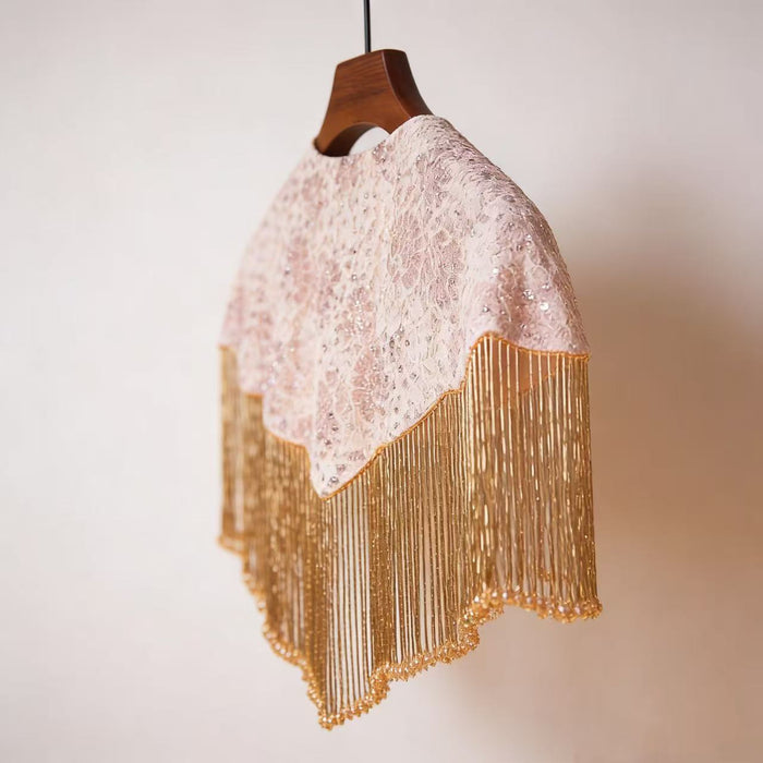 Handmade bridal shoulder cape featuring champagne gold fringe, blush embroidery, shimmering sequins, and delicate seed bead embellishments.