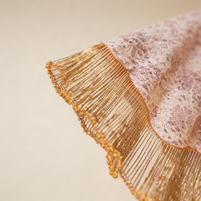 Elegant champagne gold bridal cape with handcrafted bead embroidery and flowing fringe for weddings and evening occasions.