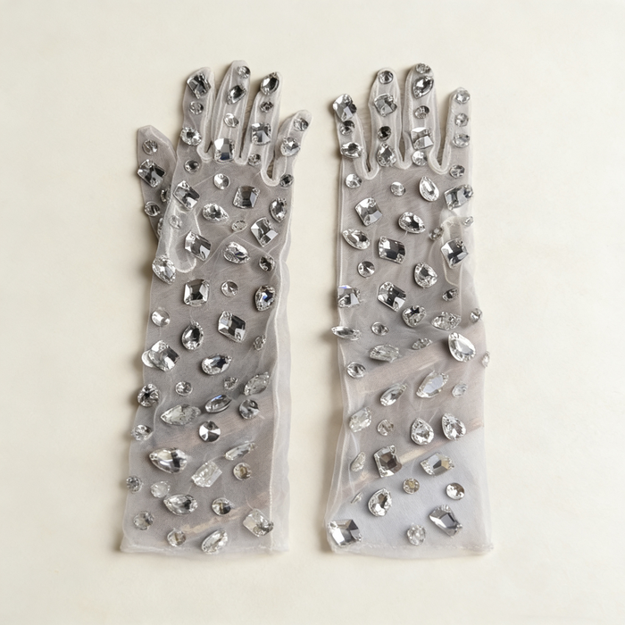 Handmade mid-length bridal gloves crafted from sheer tulle and decorated with individually hand sewn crystal rhinestones.