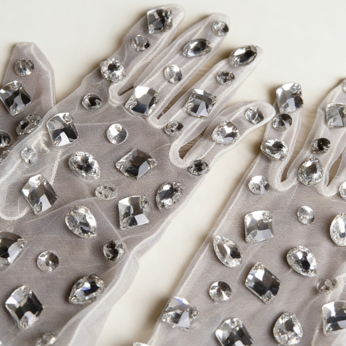 Handmade mid-length bridal gloves crafted from sheer tulle and decorated with individually hand sewn crystal rhinestones.
