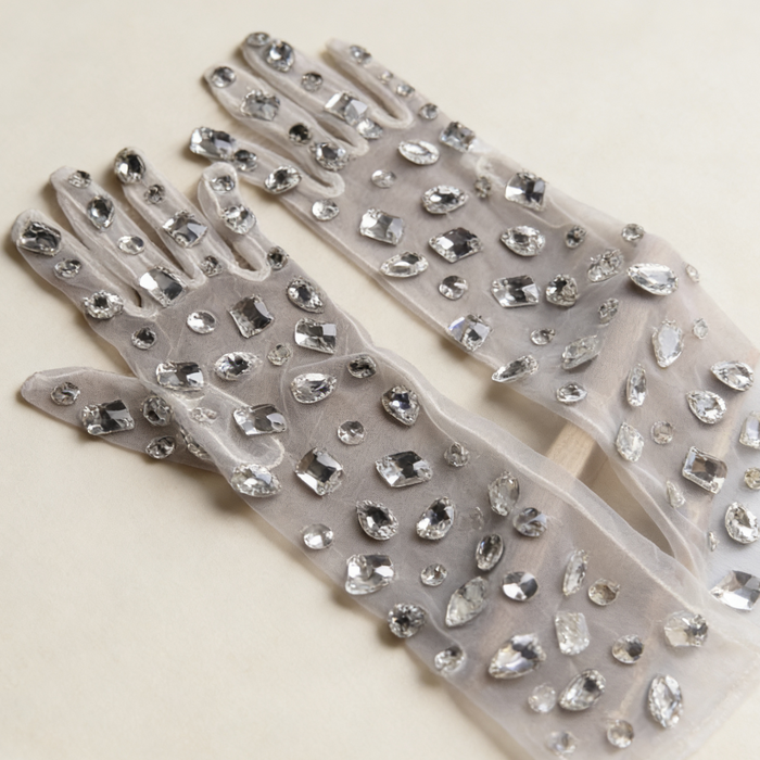 Handmade mid-length bridal gloves crafted from sheer tulle and decorated with individually hand sewn crystal rhinestones.