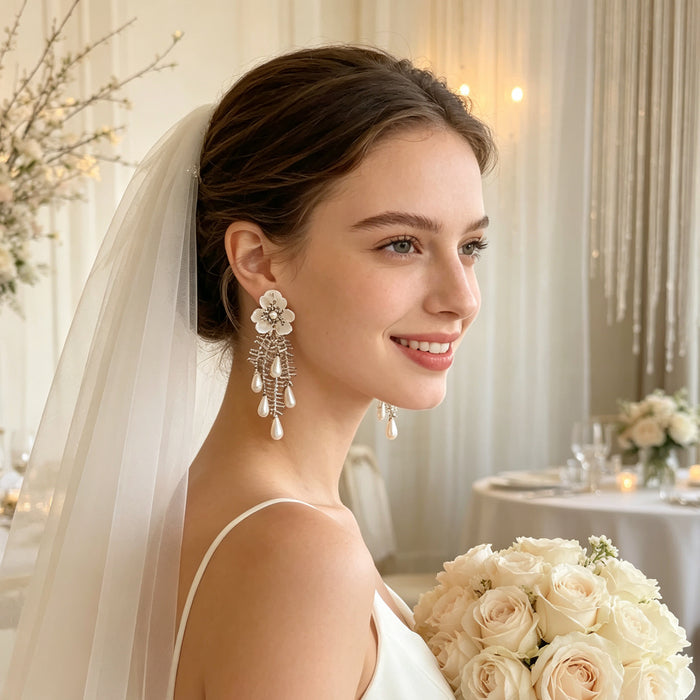 Handmade bridal stud earrings featuring resin flowers, imitation pearl drops, seed bead embroidery, and elegant cascading tassels.