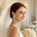 Handmade bridal stud earrings featuring resin flowers, imitation pearl drops, seed bead embroidery, and elegant cascading tassels.