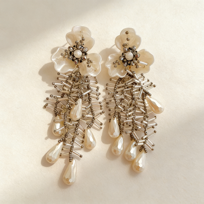 Handmade bridal stud earrings featuring resin flowers, imitation pearl drops, seed bead embroidery, and elegant cascading tassels.