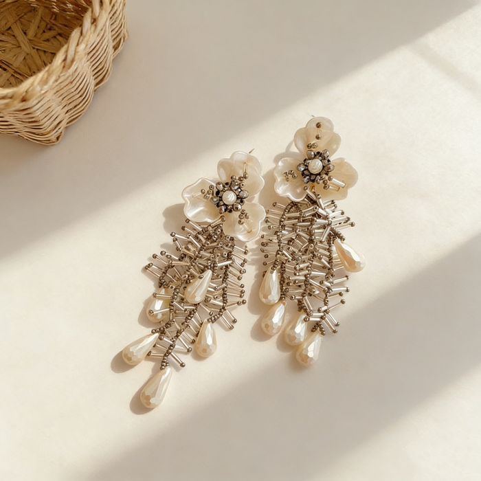 Handmade bridal stud earrings featuring resin flowers, imitation pearl drops, seed bead embroidery, and elegant cascading tassels.