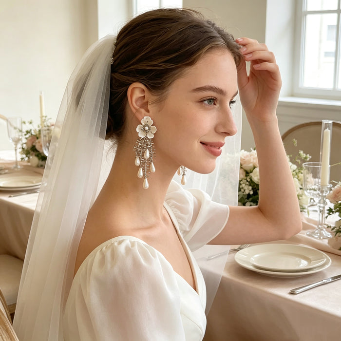 Handmade bridal stud earrings featuring resin flowers, imitation pearl drops, seed bead embroidery, and elegant cascading tassels.