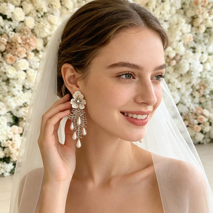 Handmade bridal stud earrings featuring resin flowers, imitation pearl drops, seed bead embroidery, and elegant cascading tassels.