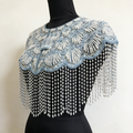 Handmade ice blue bridal cape with iridescent sequins, pearl bead embroidery, and cascading pearl-inspired fringe.