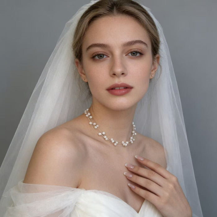 Handmade adjustable layered necklace featuring genuine freshwater pearls and 14K gold-plated hardware for elegant bridal styling.