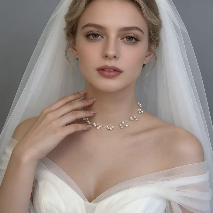 Handmade adjustable layered necklace featuring genuine freshwater pearls and 14K gold-plated hardware for elegant bridal styling.