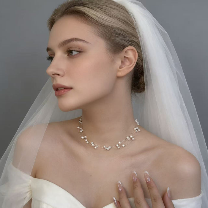 Handmade adjustable layered necklace featuring genuine freshwater pearls and 14K gold-plated hardware for elegant bridal styling.