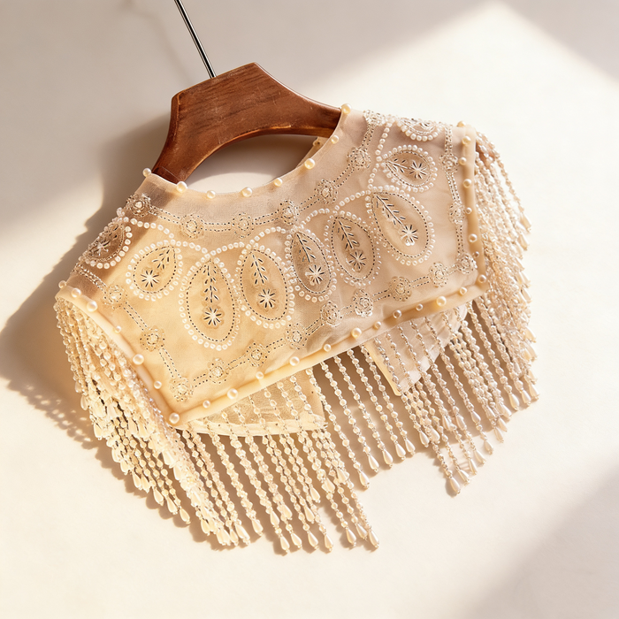 Handmade bridal shoulder cape with sheer tulle, faux pearls, sequins, seed bead embroidery, and cascading beaded fringe.
