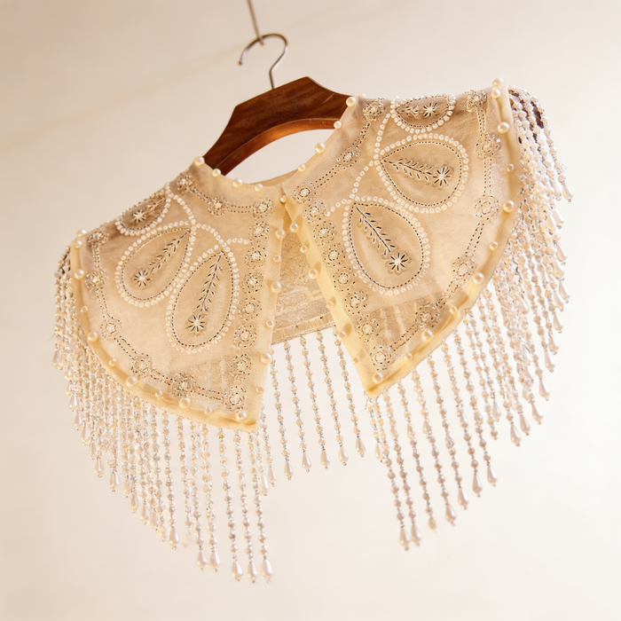 Handmade bridal shoulder cape with sheer tulle, faux pearls, sequins, seed bead embroidery, and cascading beaded fringe.