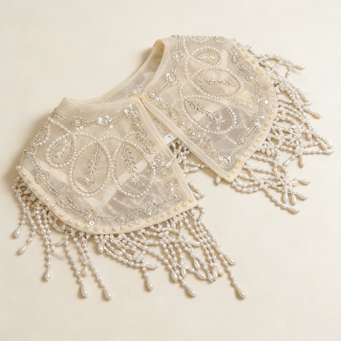 Elegant pearl embroidered bridal cape featuring delicate beaded fringe for weddings and formal occasions.