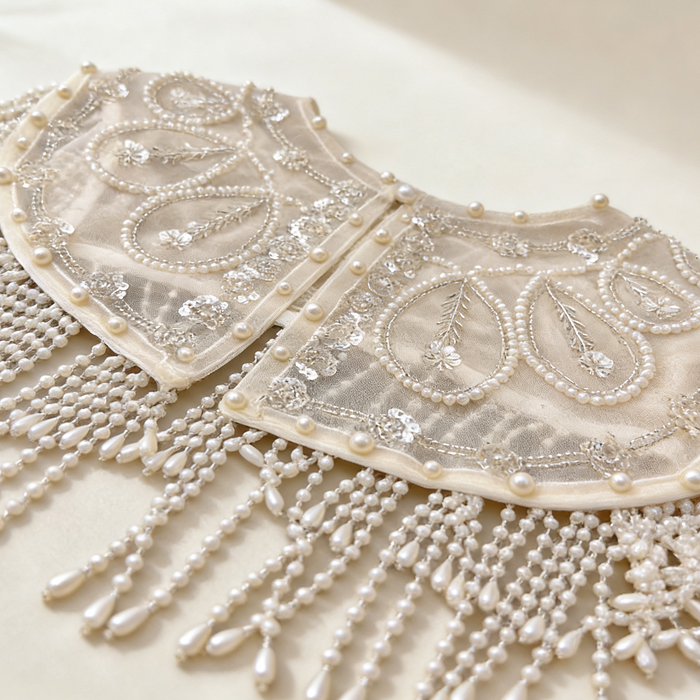 Elegant pearl embroidered bridal cape featuring delicate beaded fringe for weddings and formal occasions.