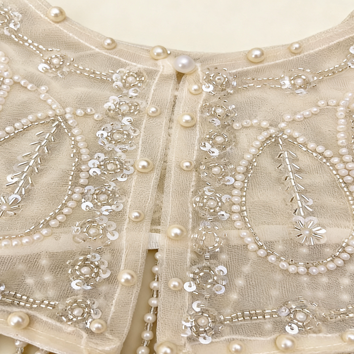 Elegant pearl embroidered bridal cape featuring delicate beaded fringe for weddings and formal occasions.
