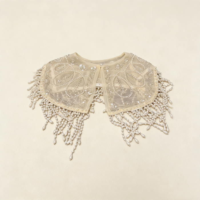 Elegant pearl embroidered bridal cape featuring delicate beaded fringe for weddings and formal occasions.