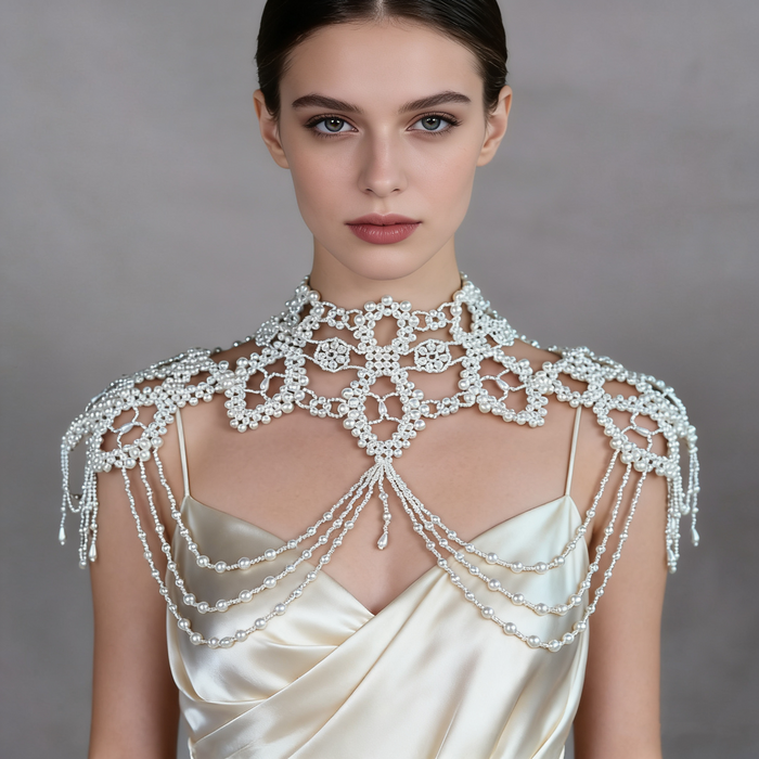 Handmade Victorian-inspired bridal shoulder jewelry featuring intricate faux pearl beadwork, layered pearl chains, and elegant shoulder draping.