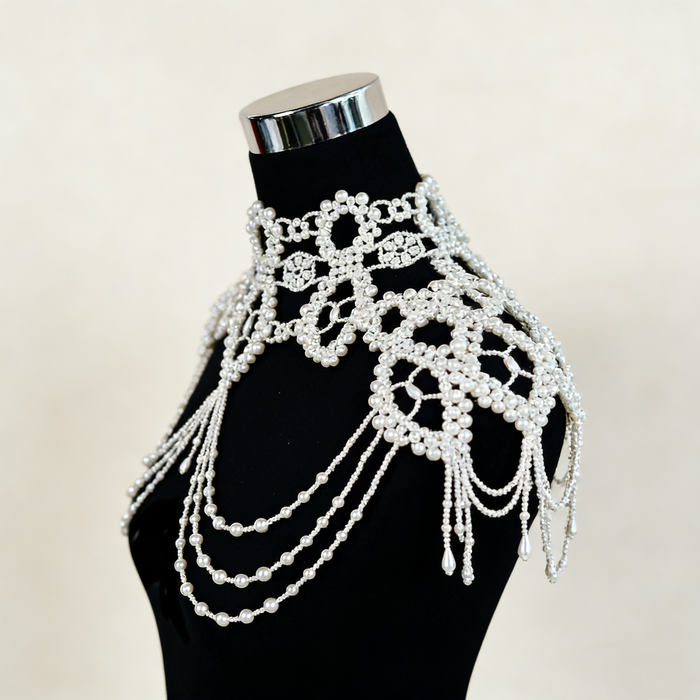 Handmade Victorian-inspired bridal shoulder jewelry featuring intricate faux pearl beadwork, layered pearl chains, and elegant shoulder draping.