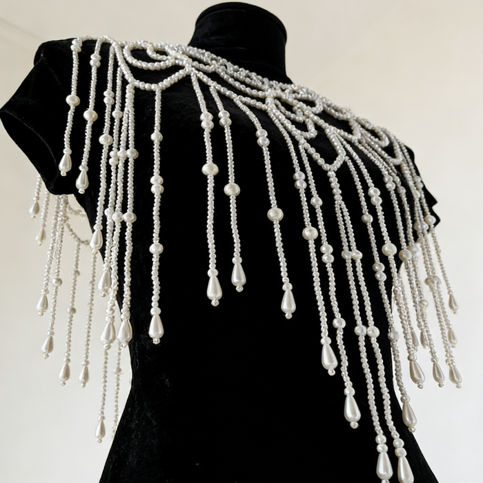 Handmade bridal shoulder necklace featuring intricate faux pearl beadwork, openwork design, and cascading pearl fringe.