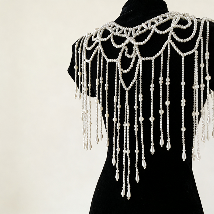Handmade bridal shoulder necklace featuring intricate faux pearl beadwork, openwork design, and cascading pearl fringe.