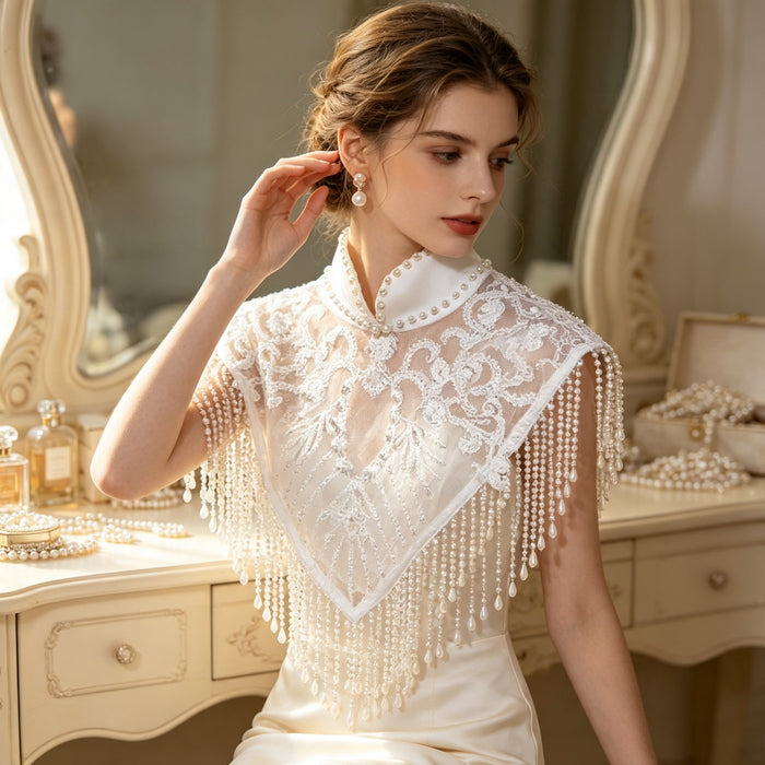 Elegant high-neck bridal shoulder cape with handcrafted pearl embroidery, soft tulle, and cascading pearl-inspired fringe.