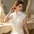 Elegant high-neck bridal shoulder cape with handcrafted pearl embroidery, soft tulle, and cascading pearl-inspired fringe.
