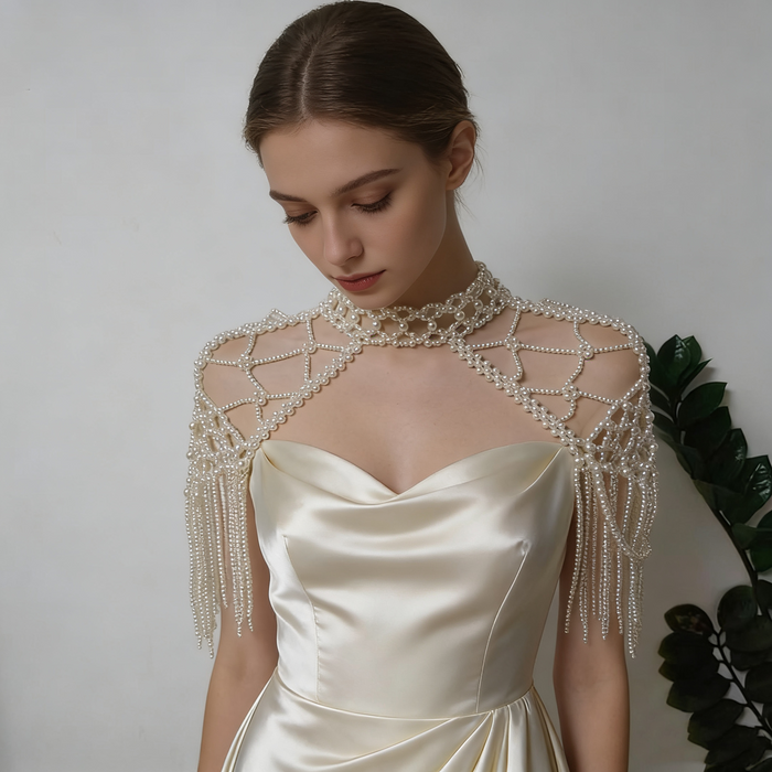 Elegant pearl shoulder wrap bridal accessory featuring layered pearl chains and vintage inspired wedding couture design.