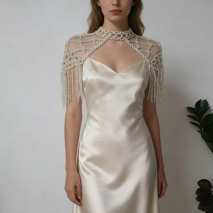 Elegant pearl shoulder wrap bridal accessory featuring layered pearl chains and vintage inspired wedding couture design.