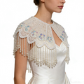Handmade bridal cape featuring hand-sewn sequin bead embroidery, iridescent floral details, and cascading faux pearl fringe.