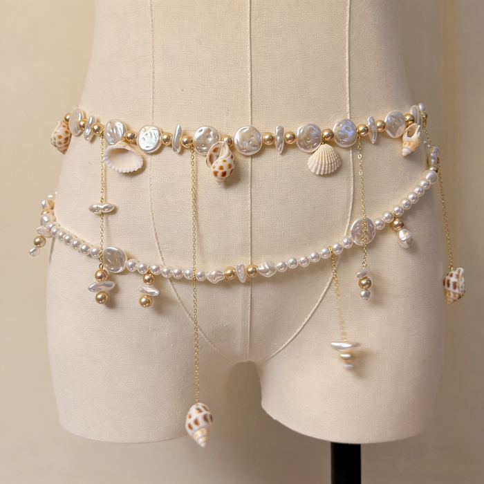 Handmade bridal waist belt featuring imitation pearls, natural seashell charms, layered gold chains, and elegant pearl tassels.