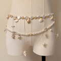 Handmade bridal waist belt featuring imitation pearls, natural seashell charms, layered gold chains, and elegant pearl tassels.
