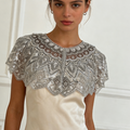 Handmade silver bridal capelet with intricate bead embroidery, shimmering sequins, and scalloped edges.