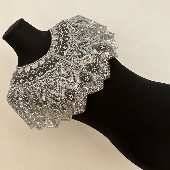 Handmade silver bridal capelet with intricate bead embroidery, shimmering sequins, and scalloped edges.