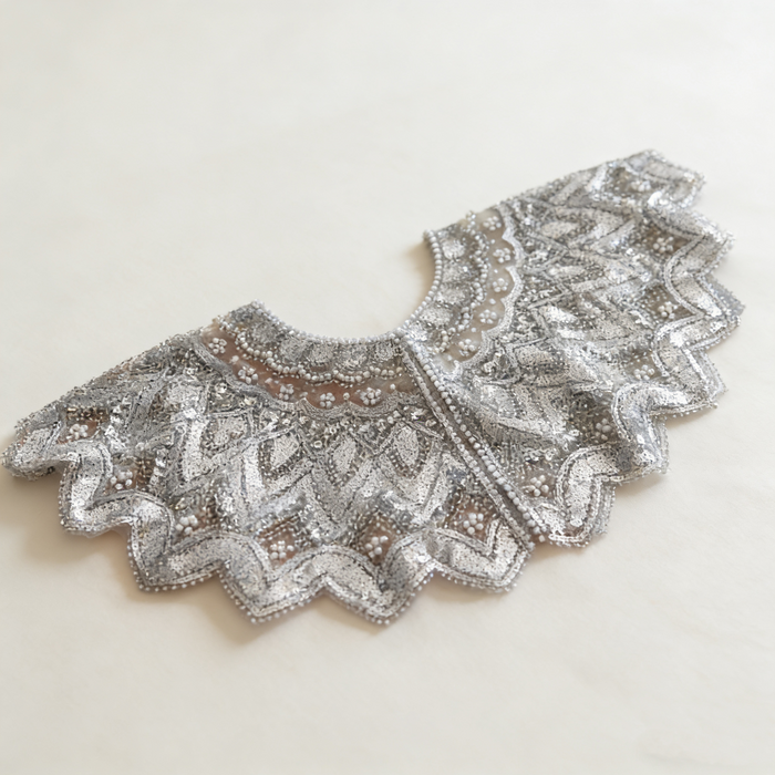 Handmade silver bridal capelet with intricate bead embroidery, shimmering sequins, and scalloped edges.