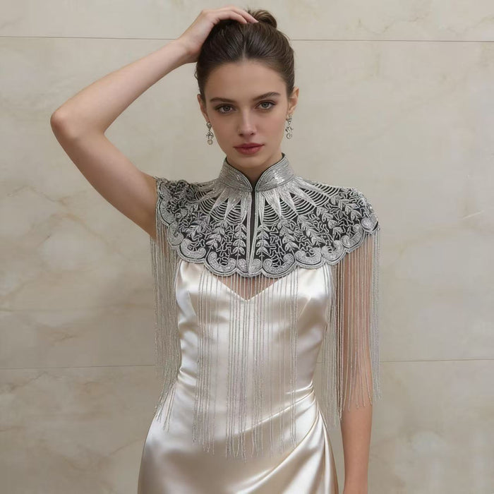 Handmade silver bridal cape featuring intricate bead embroidery, shimmering sequins, seed beads, and flowing metallic fringe.