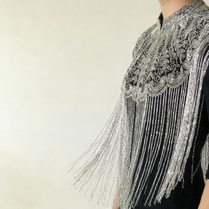 Elegant Art Deco inspired shoulder cape with silver embroidery and cascading fringe for bridal and evening wear.
