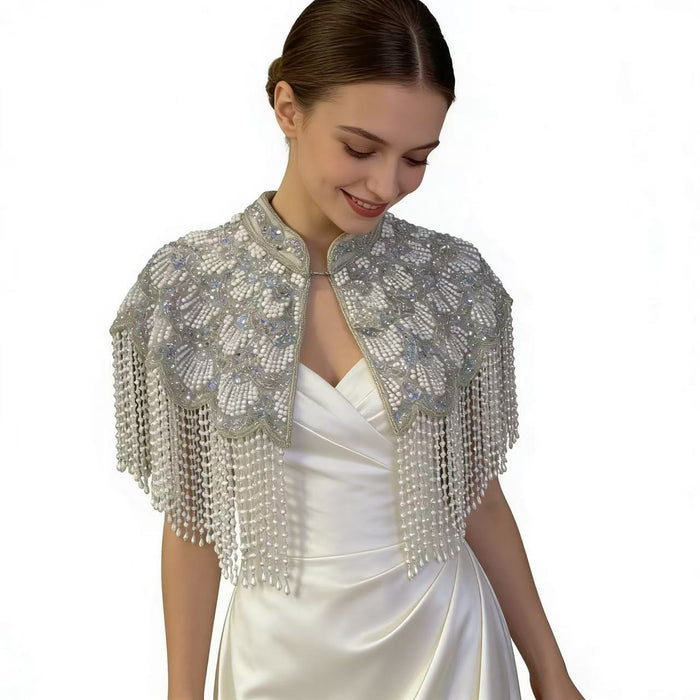 Handmade silver white bridal cape featuring pearl bead embroidery, shimmering sequins, and cascading pearl-inspired fringe.