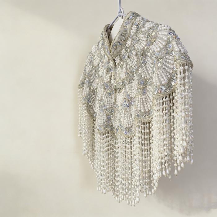 Elegant silver white bridal shoulder cape with handcrafted pearl embroidery and flowing pearl fringe for weddings.