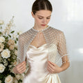 Handwoven pearl beaded bridal cape with geometric seed bead pattern and pearl fringe.