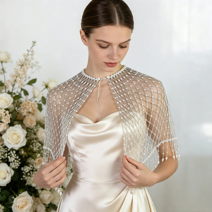 Handwoven pearl beaded bridal cape with geometric seed bead pattern and pearl fringe.